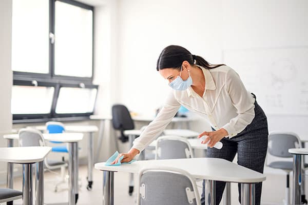 Cleaning desks in classroom